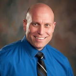 Professional team of six standing in front of Horvath Vision Care sign.