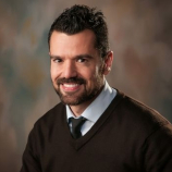 Professional team of six standing in front of Horvath Vision Care sign.