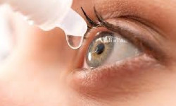 Close-up of an eye receiving eye drops.