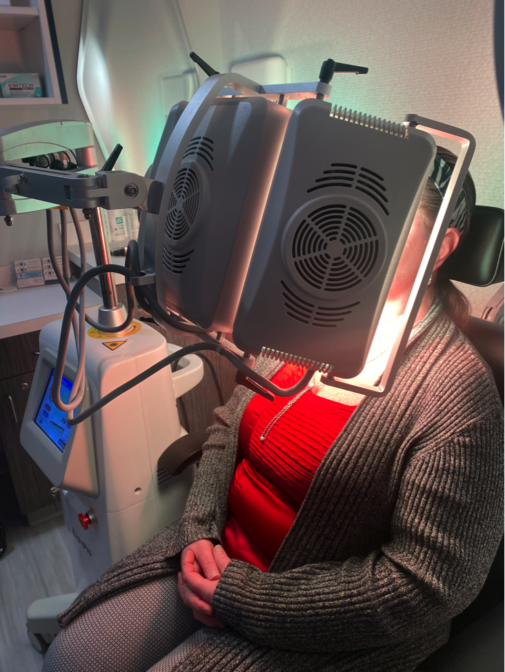 Person undergoing a futuristic VR therapy session in a neon-lit room.