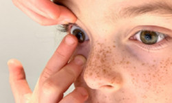 Professional team of six standing in front of Horvath Vision Care sign.